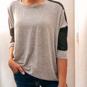 Three quarter sleeve two tone grey/ black shirt.